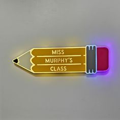 a yellow pencil with the words miss murphy's class written on it is lit up