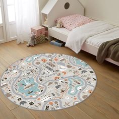 a child's bedroom with a round rug in the shape of a city map