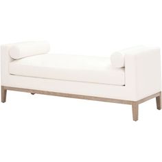 a white couch sitting on top of a wooden frame