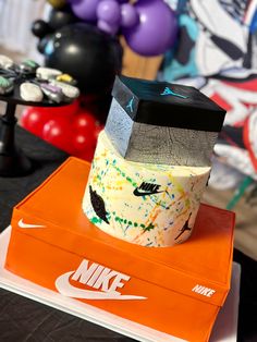 a nike cake sitting on top of an orange box