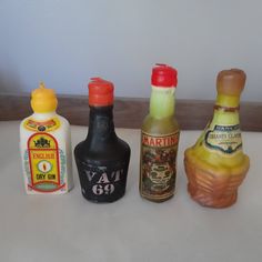 five miniature bottles are lined up on the counter