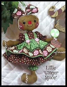 a teddy bear dressed up as a little ginger in a green dress with pink and white polka dots