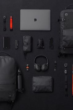 an assortment of electronics and accessories laid out on a black surface