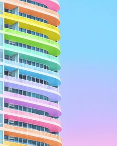 a tall multicolored building against a blue sky