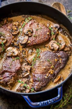 steak with mushrooms and mushroom sauce in a skillet