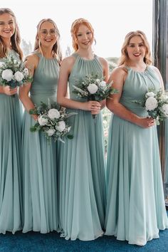 the bridesmaids are all dressed in mint green chiffon dresses and bouquets