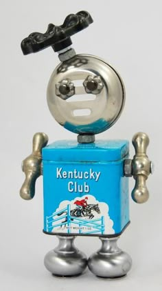 a metal toy with a blue box on it's head