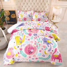 a bed with pink, yellow and blue animals on it