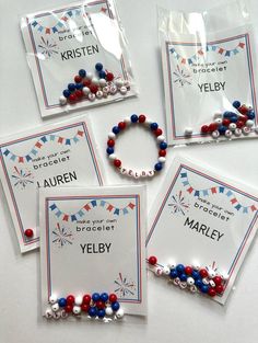 four red, white and blue beaded bracelets in plastic bags on a table