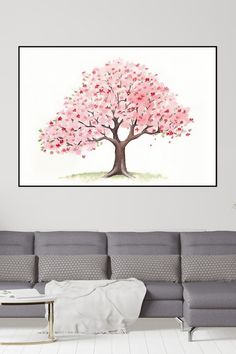 a living room with a couch, coffee table and large pink tree on the wall