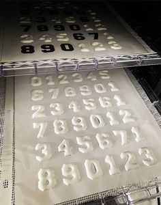 the letters and numbers are cut out of plastic sheeting to look like they have been printed on