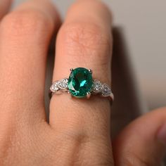 This ring features a 7*9mm oval cut lab grown emerald and sterling silver finished with rhodium. Customization is available. It is made by hand, and it will take about 7 days to finish the ring after your payment is completed. Main stone: lab emerald Main stone weight: Approx 1.75 ct Metal type: sterling silver finished with rhodium Accent stone: cz Customization is available, I also can make it with 14k solid gold (white or yellow or rose) and diamond accent stone, just feel free to contact me. Oval Emerald Birthstone Ring In White Gold, Oval Emerald Jewelry For Promise, Oval Emerald Promise Jewelry, Oval Emerald Birthstone Ring For Anniversary, Promise Emerald Ring With Diamond Oval Shape, Oval Emerald Anniversary Birthstone Ring, Oval Emerald Sterling Silver Promise Ring, Oval Sterling Silver Emerald Promise Ring, Oval Emerald Promise Ring In Sterling Silver