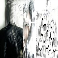 an anime character with long hair standing in front of graffiti