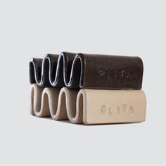 three pieces of chocolate are stacked on top of each other, with the word olita printed on them