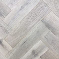 an image of wood flooring that looks like herringbones