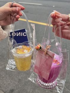 two people holding plastic bags with food in them