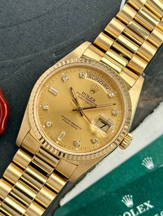 This Rolex Day Date 18238 dates back to 1995 (W-serial). The watch is in overall excellent condition. The case has nice sharp edges, even brushing and clean sides with only very minor signs of wear. The sapphire crystal is in perfect condition and protects the beautiful gold dial with diamond markers. The day indication is featured in English. The iconic fluted bezel in yellow gold is in great condition. The president bracelet has only some minor stretch. The caliber 3155 movement was fully serv Rolex Day Date, Watch Model, Brushing, Watch Brands, Luxury Watches, Full Set, Rolex, Dates, Sapphire