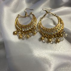 Elegant Boho Simulated Diamond Dangling Earrings, New Without Tags Festive White Metal Chandelier Earrings, Bohemian Gold Crystal Earrings For Party, White Metal Danglers For Celebration, White Metal Drop Earrings, White Metal Chandelier Earrings, Golden Earrings Indian, Desi Earrings, Diamond Dangling Earrings, Jhumka Designs