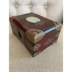 an old wooden box sitting on top of a couch