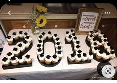 a table topped with cupcakes covered in frosting and the number 20 spelled out