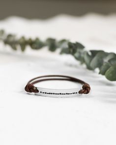 "𝗘𝗮𝘀𝘆 𝗧𝗼 𝗦𝘁𝘆𝗹𝗲, 𝗠𝗮𝗱𝗲 𝗧𝗼 𝗟𝗮𝘀𝘁 Our classic leather bar bracelets make for the perfect everyday piece, personalized with your most special sentiments, moments, and memories! These bracelets feature a neutral, unisex design and an adjustable band. 𝗠𝗮𝘁𝗲𝗿𝗶𝗮𝗹𝘀 𝗪𝗲 𝗨𝘀𝗲 This bracelet is made with 2mm leather and sturdy aluminum, 14k yellow gold filled, or sterling silver pieces. It is safe to wear in the shower, but we recommend avoiding prolonged exposure to chemicals l Minimalist Leather Bracelet With Sliding Knot For Gift, Handmade Minimalist Leather Bracelet, Minimalist Leather Bracelet With Sliding Knot As Gift, Personalized Minimalist Leather Bracelet For Friendship, Silver Leather Bracelet With Hand Stamped Details For Everyday, Adjustable Everyday Leather Bracelet, Minimalist Engraved Leather Bracelet For Everyday, Minimalist Engraved Leather Bracelet Gift, Adjustable Stamped Leather Bracelet For Everyday