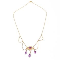 A fine Edwardian style festoon necklace.  In 14 karat yellow gold.  Centered on an ornate gold yolk with a bezel-set oval-cut amethyst.   Supporting 3 drops with freshwater river pearls and briolette-cut amethysts and flanked by several festooned swags punctuated by pearl mounts to the chain.  Simply a wonderful, delicate festoon necklace!  Date:  20th Century  Overall Condition: It is in overall good, as-pictured, used estate condition with some fine & light surface scratches and other signs of expected light wear consistent with age.  Fineness: Marked 14k for gold fineness.   Marks: Marked 14 to the clasp.  Gemstone Measurements: Amethyst cabochon: ca. 6.5 x 4.23 x  3.27 mm Largest Amethyst Drop: Length: ca. 9.5 mm Diam: ca. 5.2 mm  Measurements: Chain Length: ca. 16 in. Pendant: Height: Fine Jewelry Yellow Gold Amethyst Necklaces, Fine Jewelry Amethyst Necklace In Yellow Gold, Fine Jewelry Amethyst Necklaces In Yellow Gold, Formal Purple 14k Gold Necklace, Yellow Gold Amethyst Necklace Hallmarked, Elegant Purple Oval Pendant Necklace, Art Nouveau Yellow Gold Gemstone Necklaces, Art Nouveau 14k Yellow Gold Necklace, Ornate 14k Gold Oval Necklace