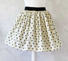 Bees Skirt Gathered  full skirt made from a beautiful 100% cotton Cream and Yellow Bees fabric. Each skirt is made by gathering the fabric onto  a 2 inch black elastic waistband. The length measures from the top of the waistband and comes in three lengths, 19", 22" or 25". Please choose length from the drop down menu. The waist measurement can be seen in the measurement guide below. Please choose waist size from the drop down menu. The skirt is pictured with a petticoat to show its potential ful Nature Skirt, Bee Fabric, Skirt Pockets, Yellow Bee, Bee Friendly, Waist Measurement, Save The Bees, Gathered Skirt, Full Skirt