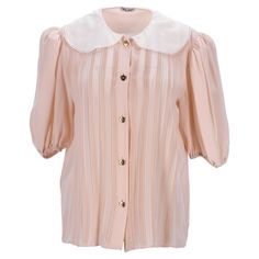 Elevate Your Wardrobe With The Miu Miu Pleated Peter Pan Collar Shirt In Peach Silk Crepe. This Enchanting Shirt Features A Delicate Peach Silk Crepe Fabric That Drapes Elegantly, Offering A Soft And Luxurious Feel. The Playful Pleated Detail And Classic Peter Pan Collar Add A Touch Of Vintage Charm, Making It A Versatile Piece For Both Sophisticated And Casual Outfits. Perfect For Adding A Hint Of Refinement To Your Everyday Look Or Dressing Up For Special Occasions, This Shirt Embodies Timeles Classic Long Sleeve Miu Miu Tops, Miu Miu Classic Long Sleeve Tops, Miu Miu Tops For Spring Workwear, Elegant Pink Tops With Collared Neckline, Feminine Pink Collared Top, Chic Short Sleeve Peach Blouse, Feminine Beige Collared Tops, Feminine Collared Beige Tops, Chic Apricot Short Sleeve Tops