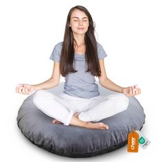 a woman is sitting in the lotus position