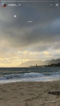 an image of the beach with waves coming in from the water and clouds above it