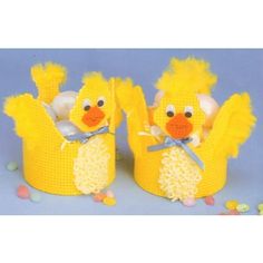 two knitted yellow chicks sitting on top of each other