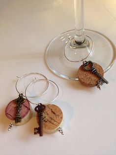 two wine glasses with corks attached to them