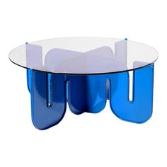 a glass table with blue legs and an oval shaped design on the top, sitting in front of a white background