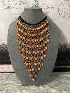 Beautiful necklace and earrings with round flowers, made with beads by Mexican artisans, it is a colorful piece that highlights any outfit. Multicolor Beaded Flower Necklace, Bohemian Multicolor Flower Shaped Jewelry, Orange Beaded Flower-shaped Jewelry, Orange Beaded Flower Jewelry, Multicolor Flower Necklace With Flower Decoration, Orange Flower-shaped Beaded Jewelry, Handmade Vintage Flower Shape Necklaces, Handmade Vintage Necklace With Flower Shape, Vintage Handmade Flower Shape Necklaces