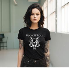 Rock 'N' Roll DJ Shirt, Vinyl Disc Jockey, Heavy Metal, Rocker, Musician, Music Lover Gift, Music Animal, Club Shirt, Unisex Short Sleeve Tee. This classic unisex jersey short sleeve tee fits like a well-loved favorite. Soft cotton and quality print make users fall in love with it over and over again. These t-shirts have-ribbed knit collars to bolster shaping. The shoulders have taping for better fit over time. Dual side seams hold the garment's shape for longer.  .: 100% Airlume combed and ring Punk Style Shirt With Band Logo And Short Sleeves, Punk Style Band Logo Shirt With Short Sleeves, Rocker Style Short Sleeve Top For Music Festivals, Rocker Style Short Sleeve Shirt For Concert, Rocker Style Letter Print Fan Merchandise Top, Rock Style Fan Merchandise Top With Short Sleeves, Black Rock And Roll Top For Concert, Rock And Roll Style Tops For Music Festivals, Rock Style Graphic Print Shirt For Concert