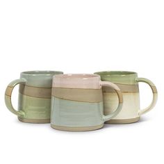 three coffee mugs sitting next to each other