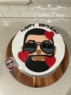 a birthday cake with a man's face and sunglasses on it