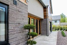 an outside view of a house with stone and brick