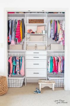 a white closet filled with lots of clothes and baskets on top of it's shelves