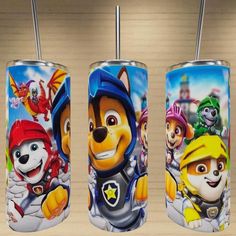 three children's tumblers with cartoon characters on them, one has a straw in it