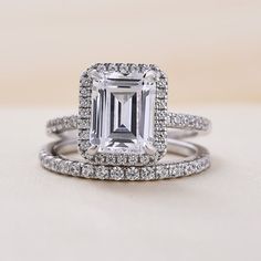 an emerald cut diamond surrounded by two rows of diamonds