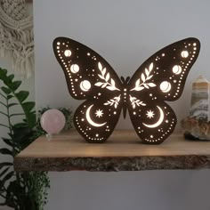 a butterfly shaped light sitting on top of a wooden table