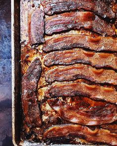 a pan filled with sliced bacon on top of a table