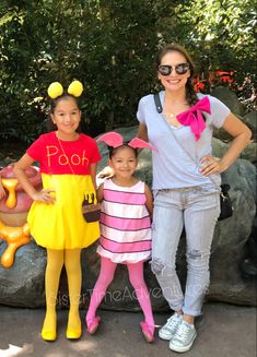 a woman and two children are standing next to each other