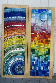 two pieces of art made out of stained glass and wood with different colors on them