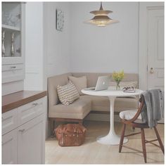 a kitchen with a table, chair and couch in it