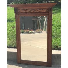 a mirror sitting on the side of a sidewalk