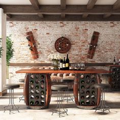 a dining room table with wine bottles on the top and chairs around it in front of a brick wall