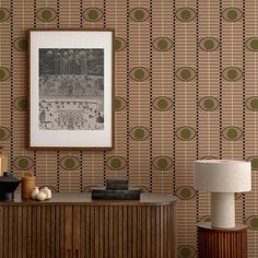 a living room with wallpaper and a painting on the wall next to a table