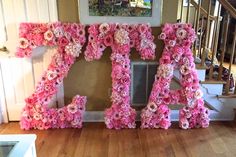 the letters are made out of pink flowers